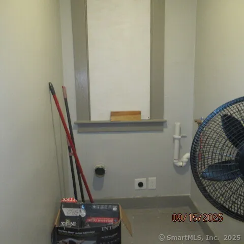 a view of a hallway with furniture