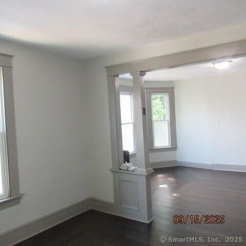 67 Burlington Avenue, Unit 69 Bristol, CT 06010 - Photo 3 of 15 an empty room with wooden floor and windows