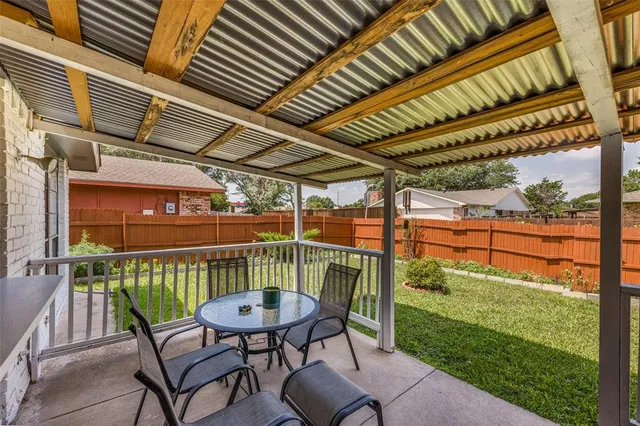 a view of a chair and table in the patio