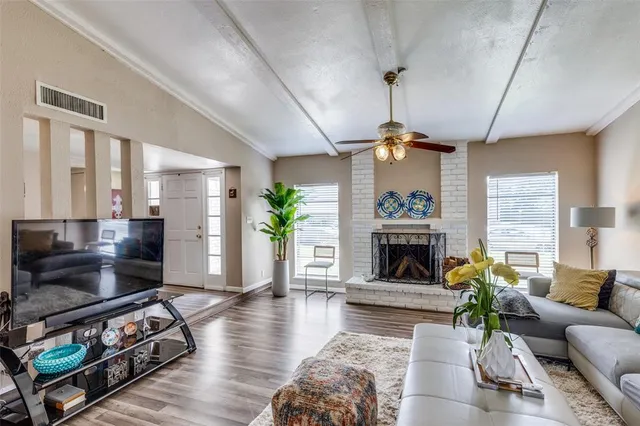 a living room with furniture a fireplace and a chandelier
