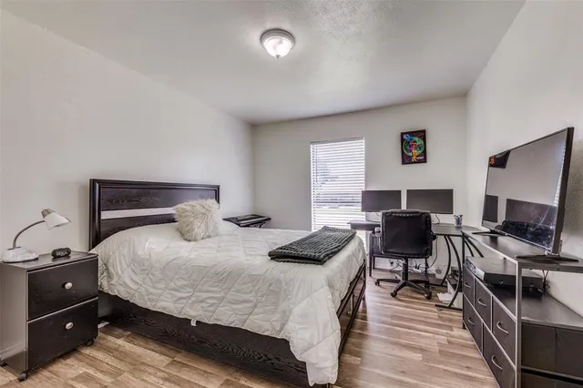 a bedroom with a bed and a desk