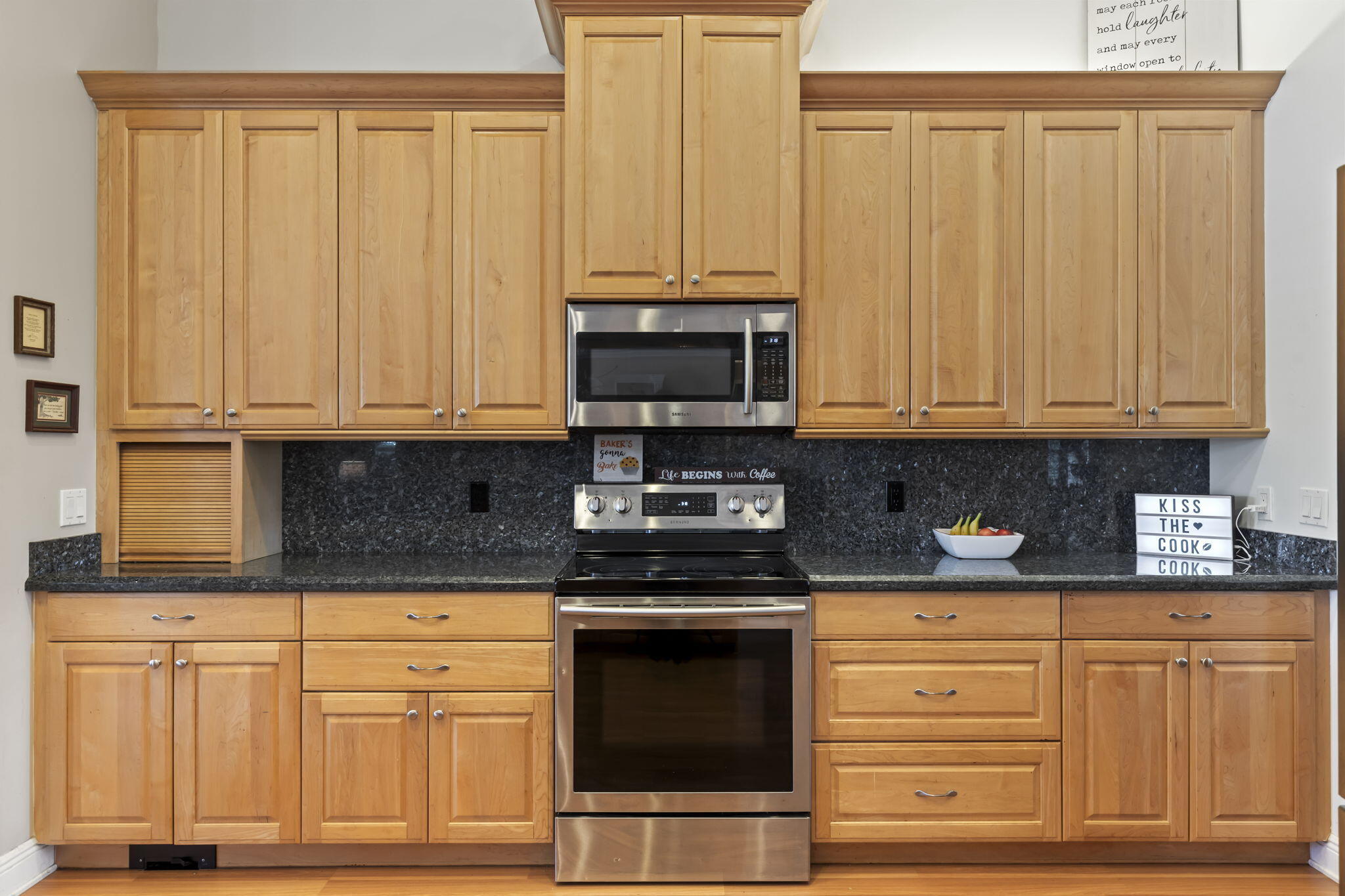 9850 Muller Road Fort Pierce, FL 34945 - Photo 13 of 52 a kitchen with stainless steel appliances granite countertop a stove a sink and white cabinets