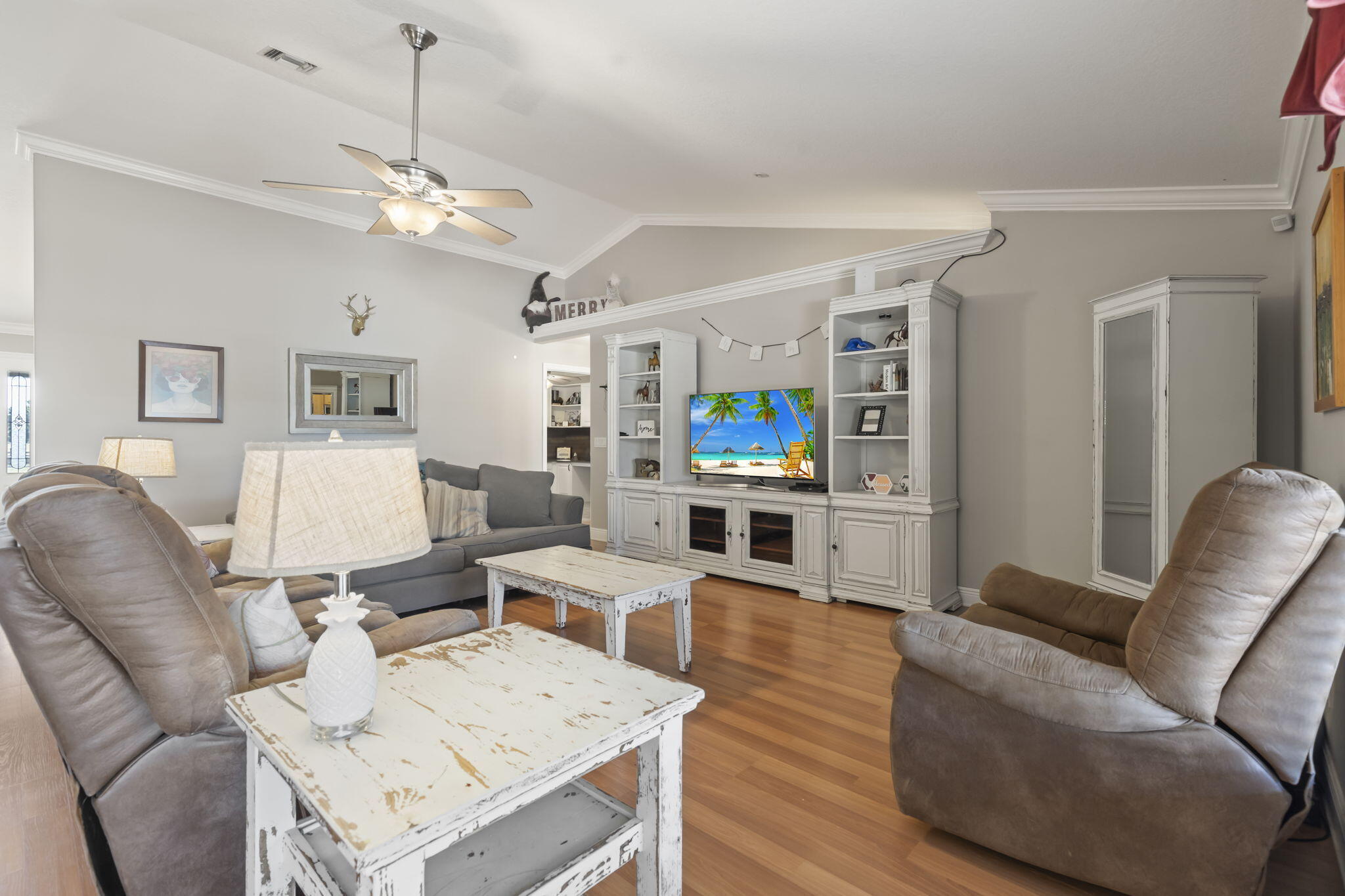 9850 Muller Road Fort Pierce, FL 34945 - Photo 16 of 52 a living room with furniture kitchen view and a chandelier