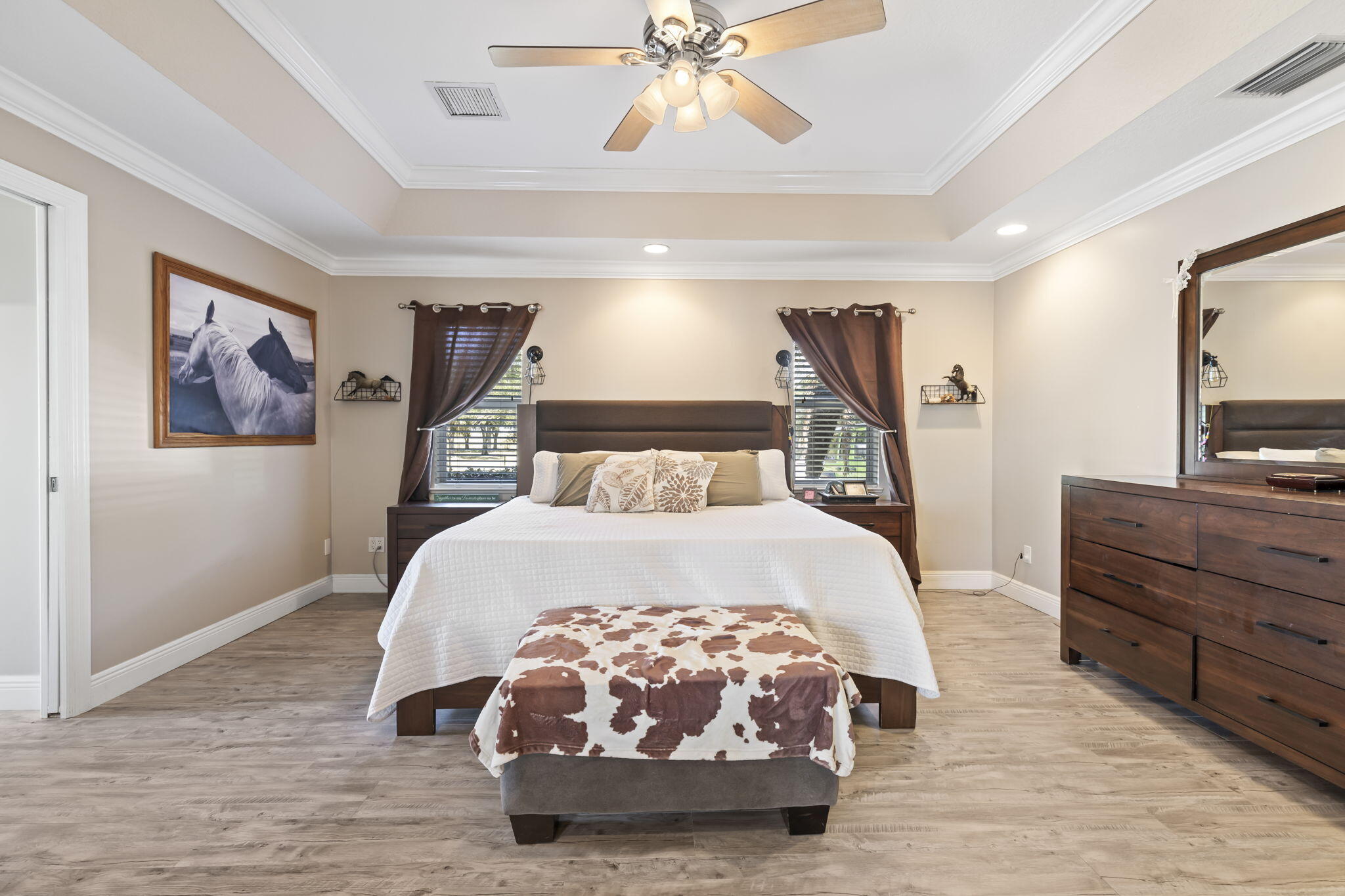 9850 Muller Road Fort Pierce, FL 34945 - Photo 17 of 52 a bedroom with a large bed and a chandelier