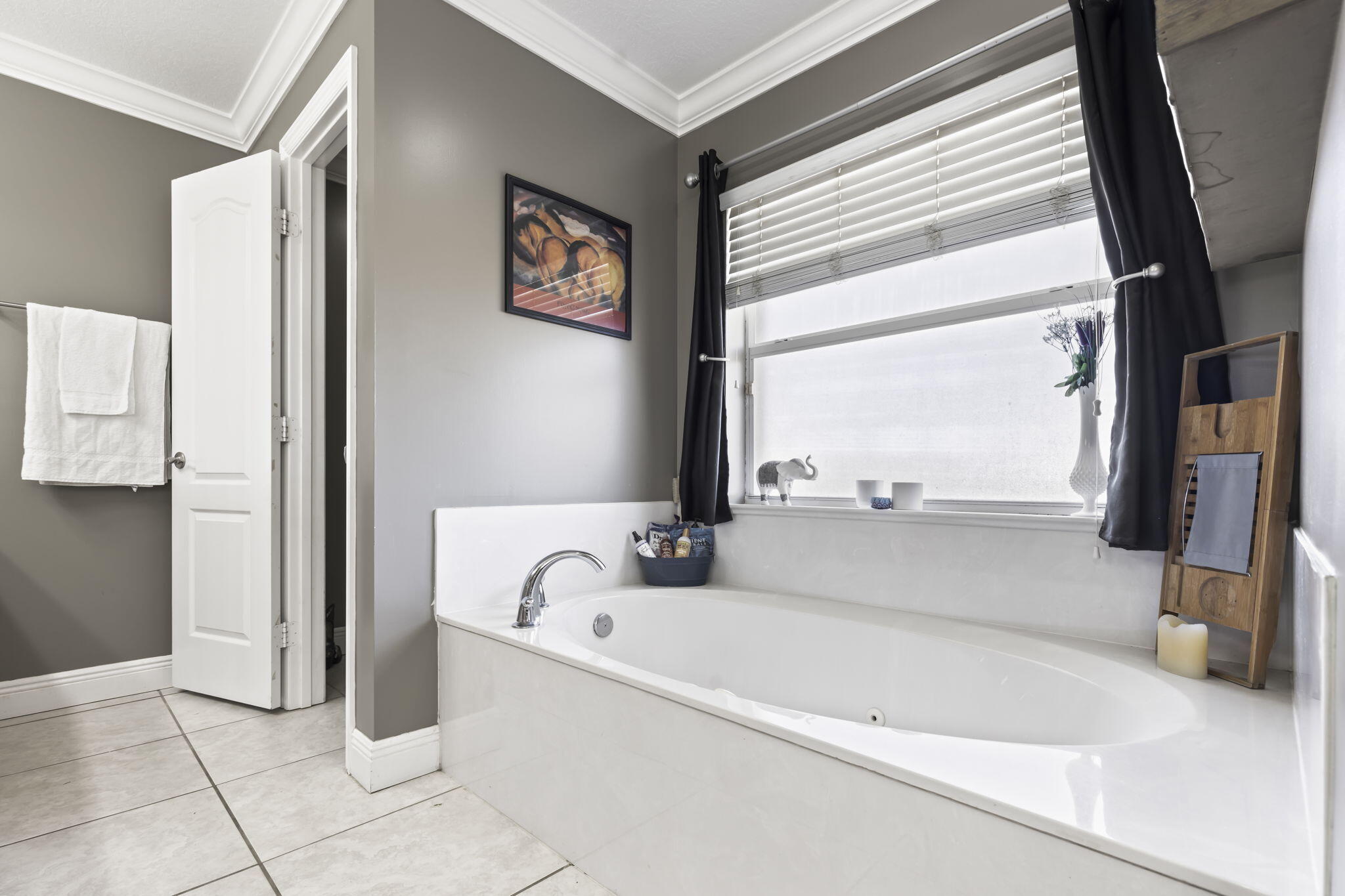 9850 Muller Road Fort Pierce, FL 34945 - Photo 22 of 52 a bathroom with a bathtub and a window