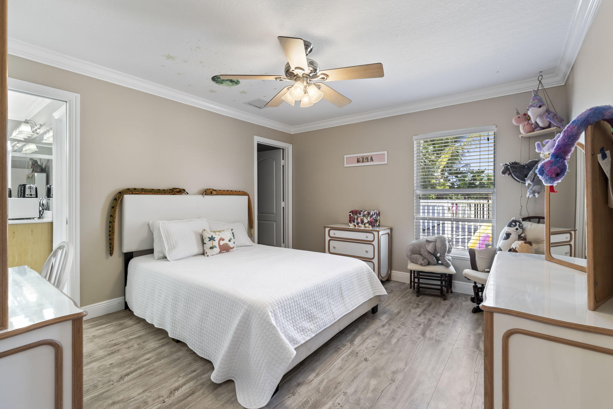 9850 Muller Road Fort Pierce, FL 34945 - Photo 24 of 52 a bedroom with a bed and a chandelier