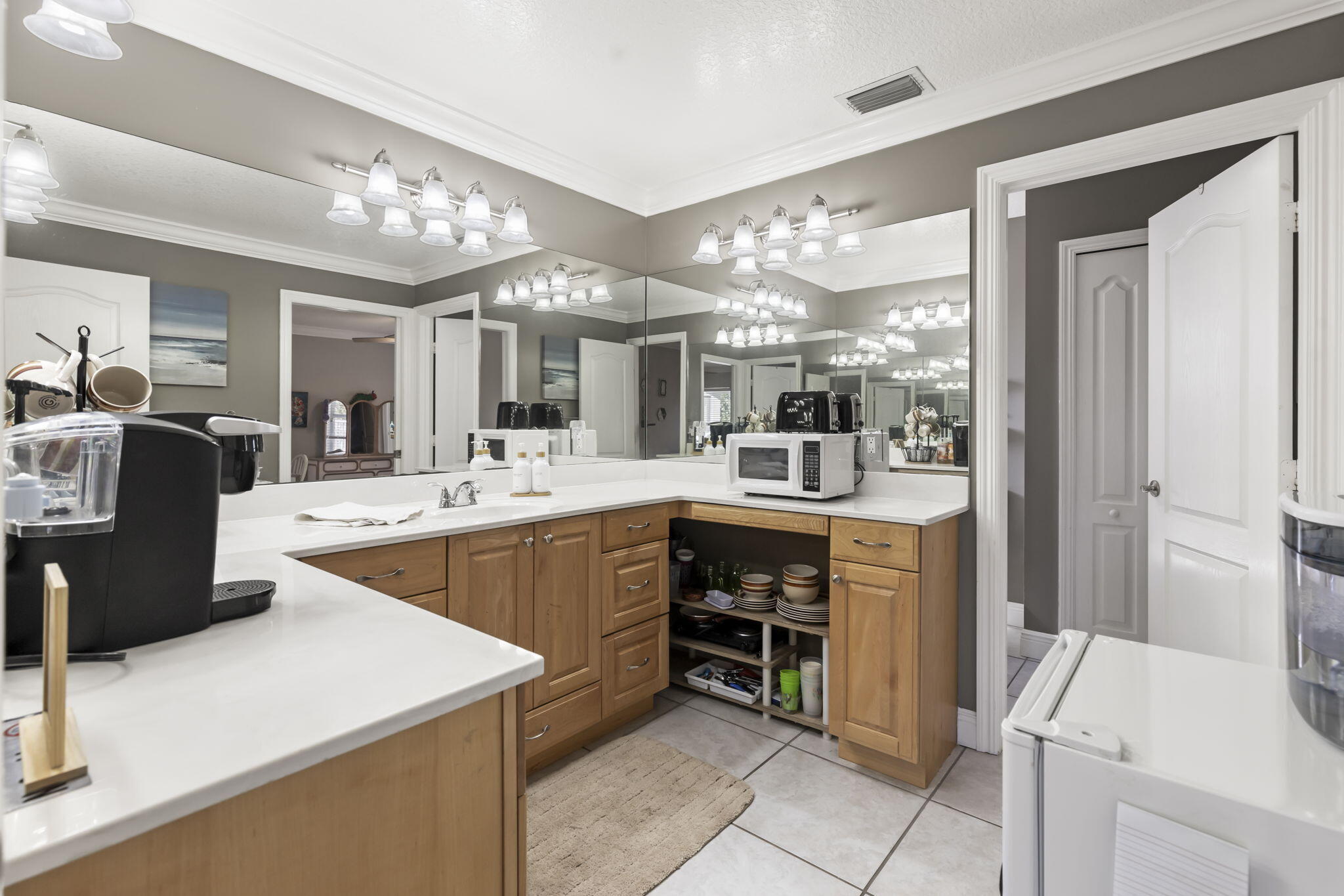 9850 Muller Road Fort Pierce, FL 34945 - Photo 25 of 52 a kitchen with kitchen island cabinets and refrigerator