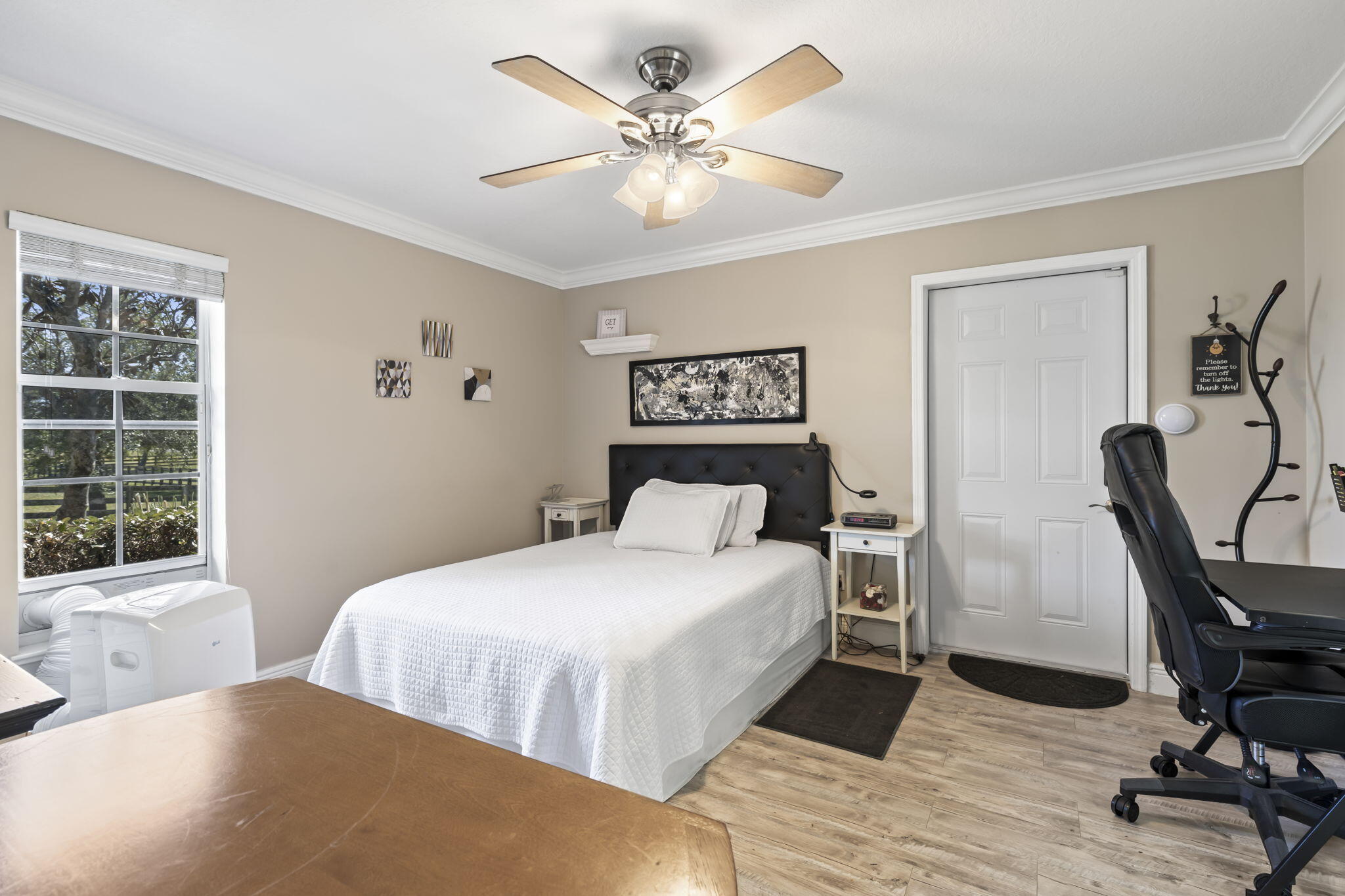 9850 Muller Road Fort Pierce, FL 34945 - Photo 27 of 52 a bedroom with a bed a table and chair