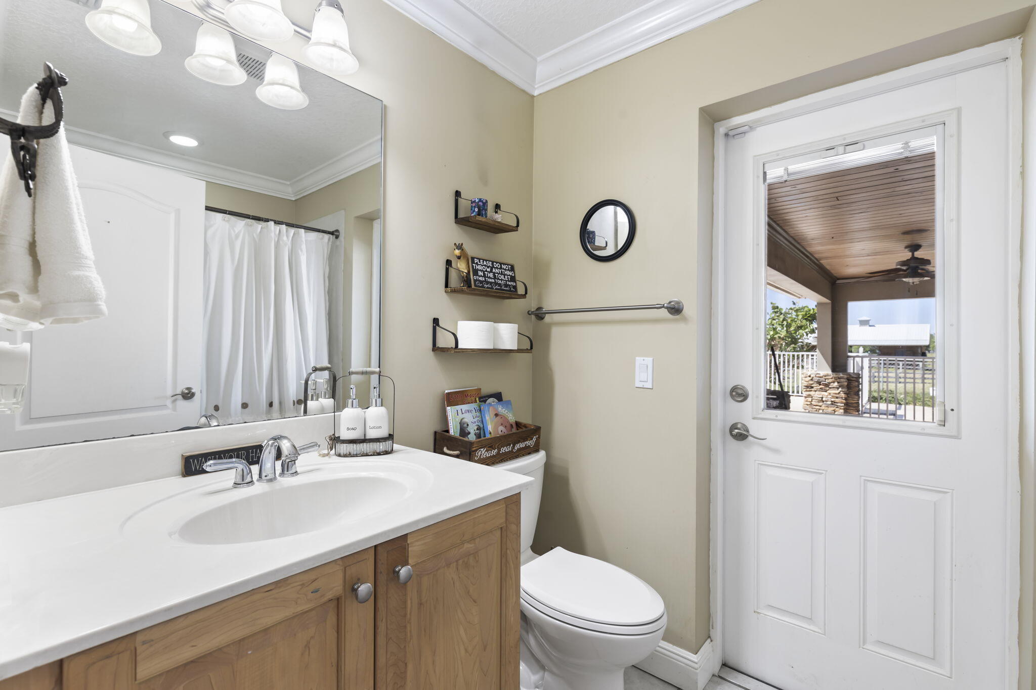 9850 Muller Road Fort Pierce, FL 34945 - Photo 30 of 52 a bathroom with a sink vanity mirror and toilet