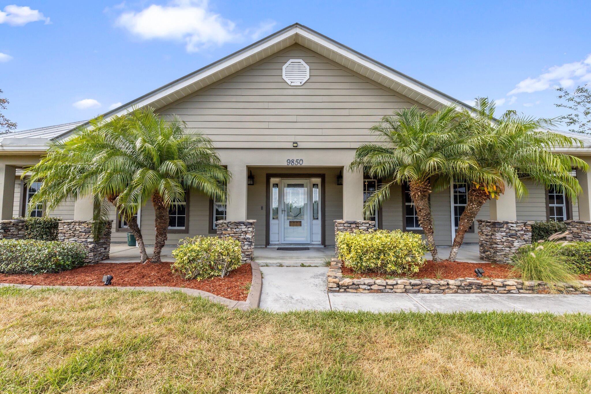 9850 Muller Road Fort Pierce, FL 34945 - Photo 3 of 52 a front view of a house with garden