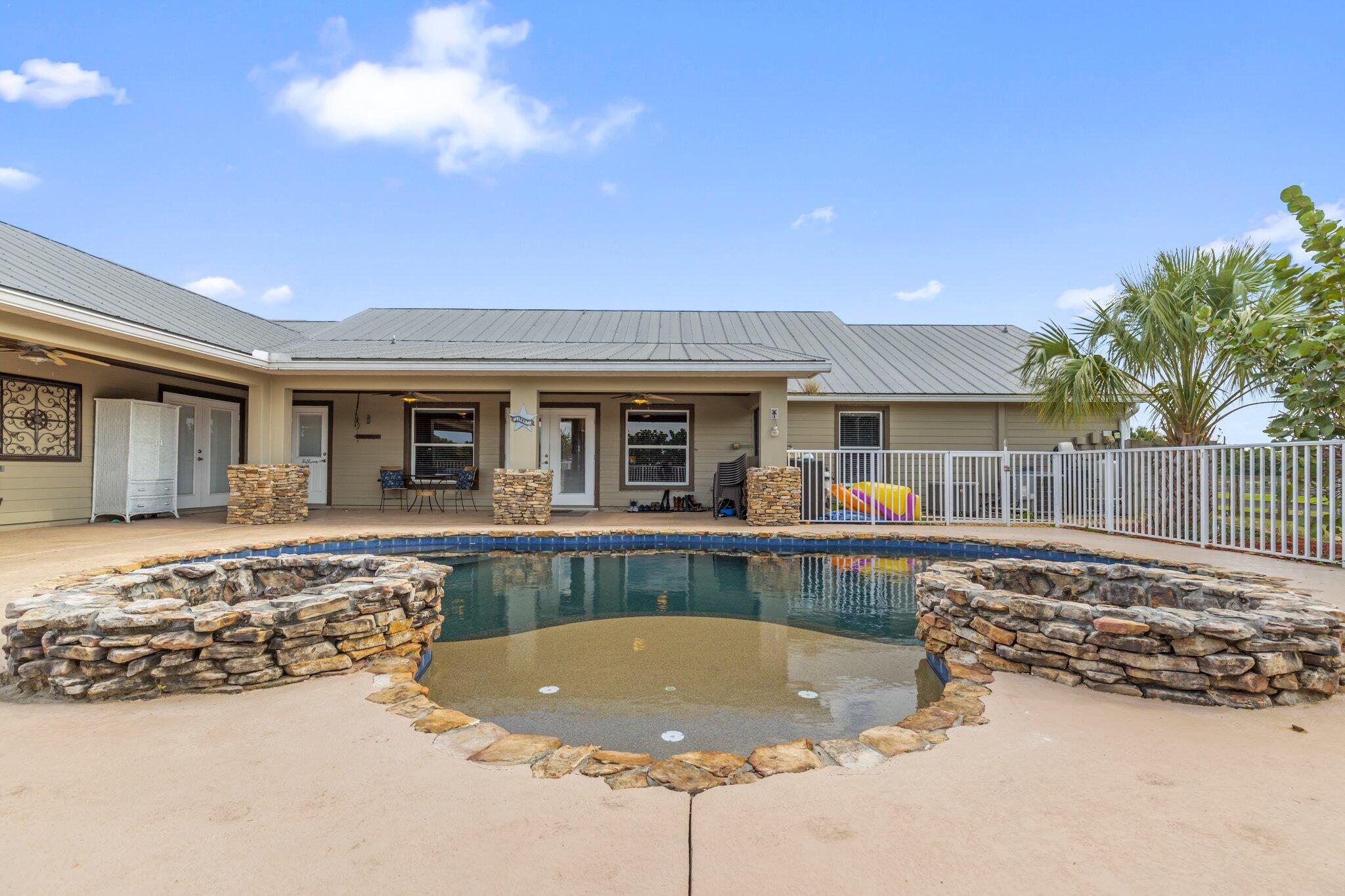 9850 Muller Road Fort Pierce, FL 34945 - Photo 38 of 52 a view of a house with swimming pool and sitting area