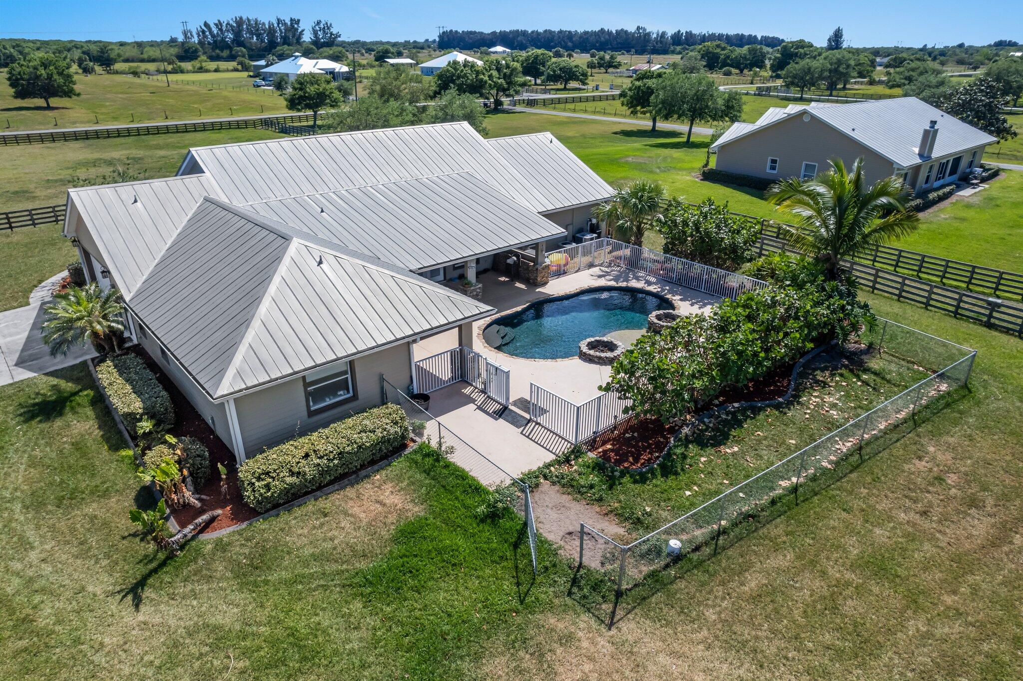 9850 Muller Road Fort Pierce, FL 34945 - Photo 39 of 52 an aerial view of a house with garden space and street view