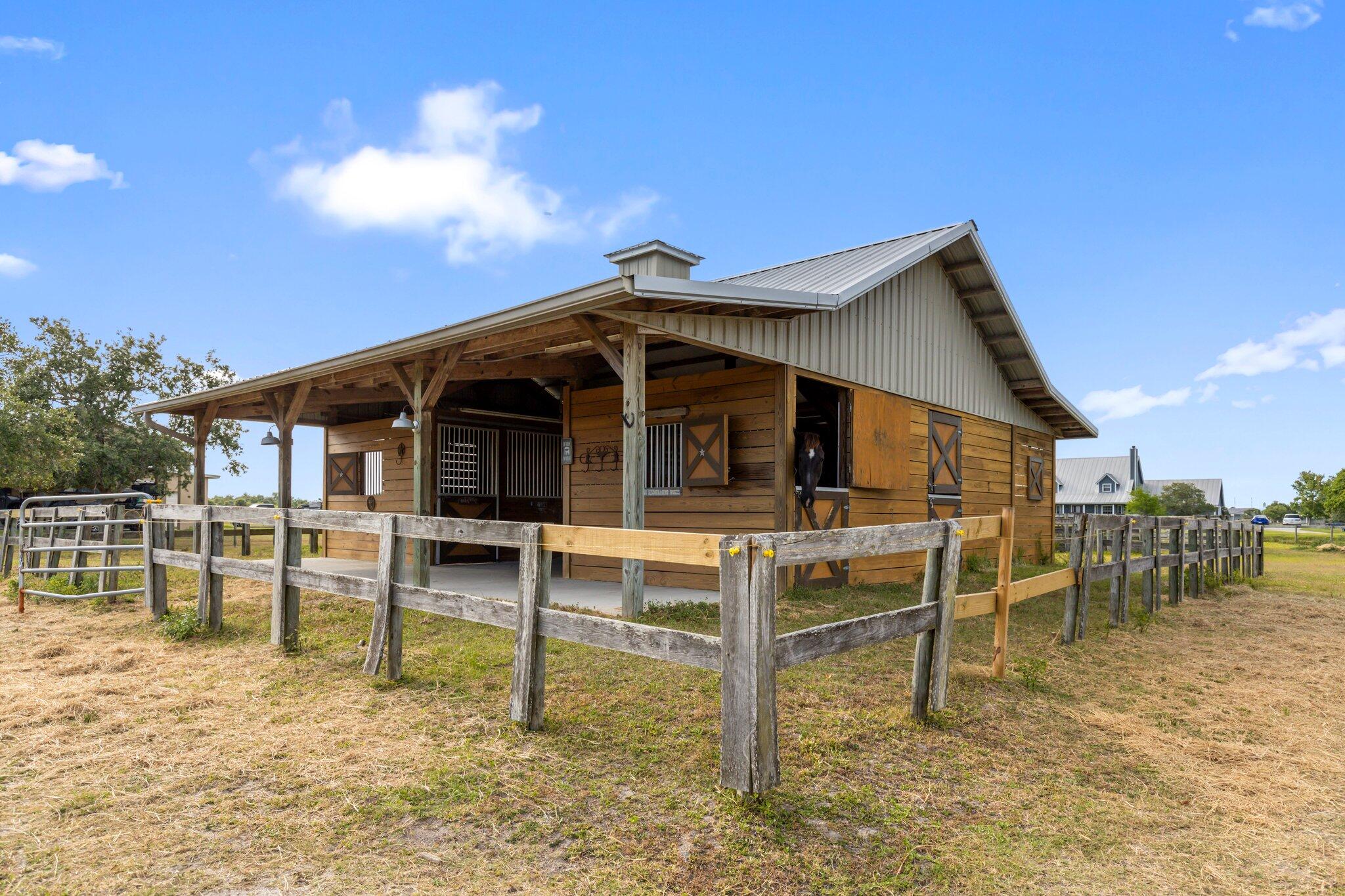 9850 Muller Road Fort Pierce, FL 34945 - Photo 42 of 52 a view of a house with a yard porch and sitting area