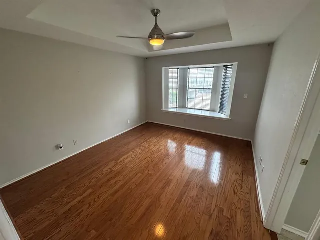 a view of a hallway with workspace and a window