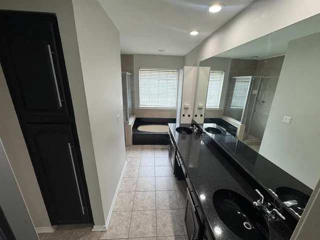 a bathroom with a tub and a window