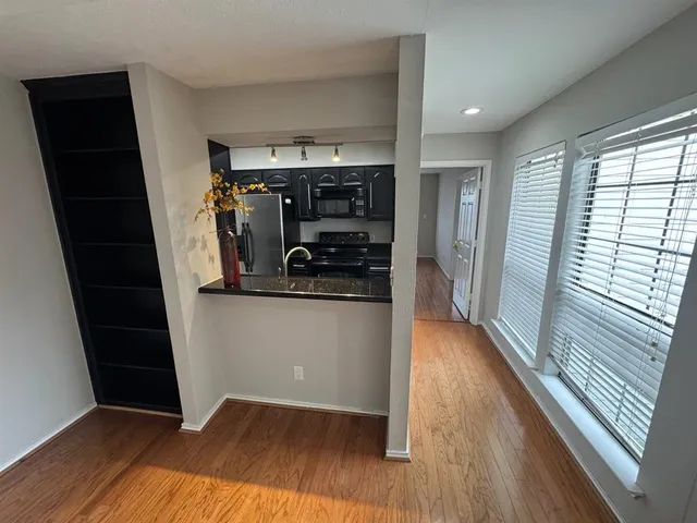 a view of a kitchen from a hallway