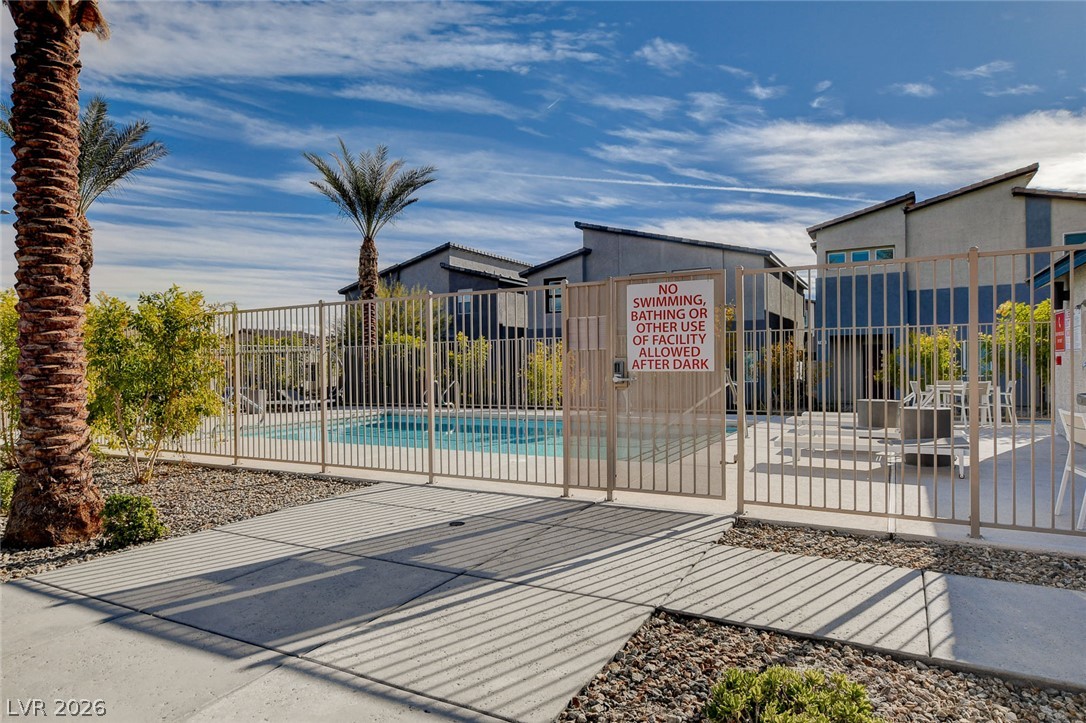 7330 North Decatur Boulevard, Unit 6 North Las Vegas, NV 89084 - Photo 25 of 42 Lush landscaping and a shimmering pool are fenced for safety, creating a private oasis.