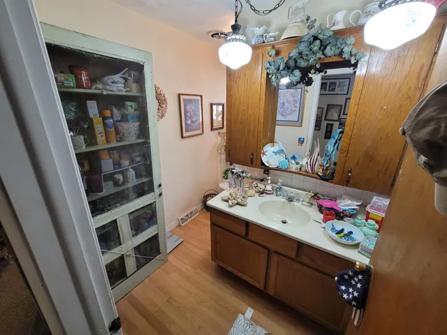 a bathroom with a sink a vanity and a mirror
