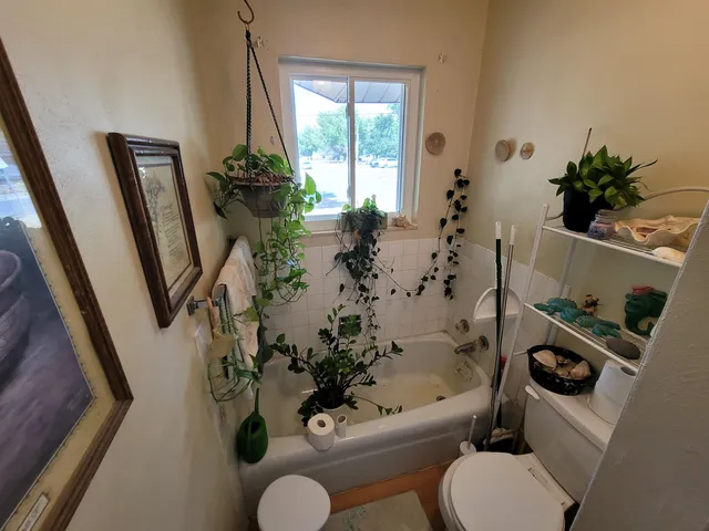 a bathroom with a toilet sink and tub