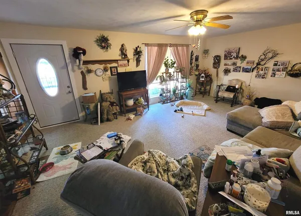a bedroom with furniture and a flat screen tv