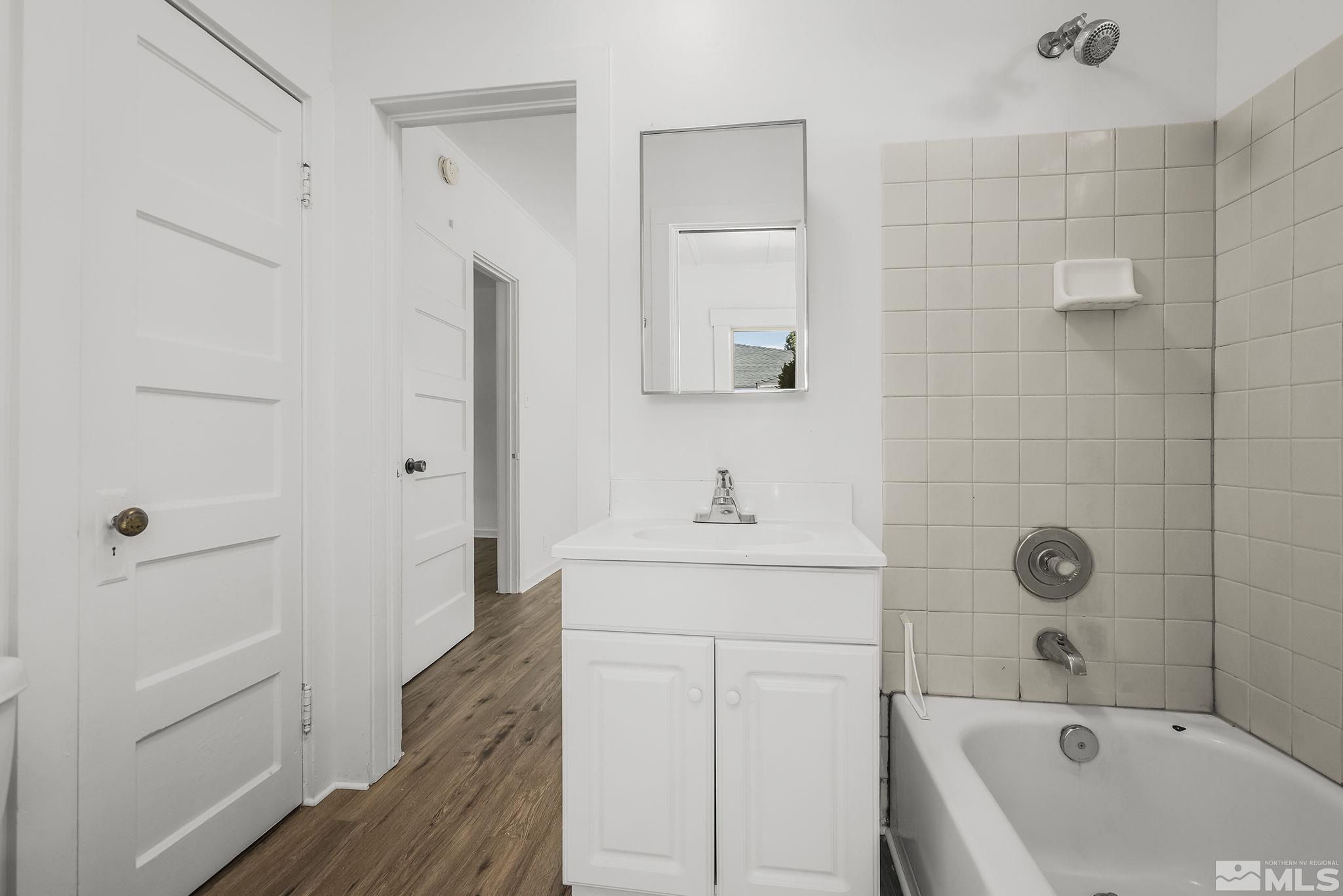 971 Lester Avenue Reno, NV 89502 - Photo 11 of 15 a bathroom with a sink a toilet and shower