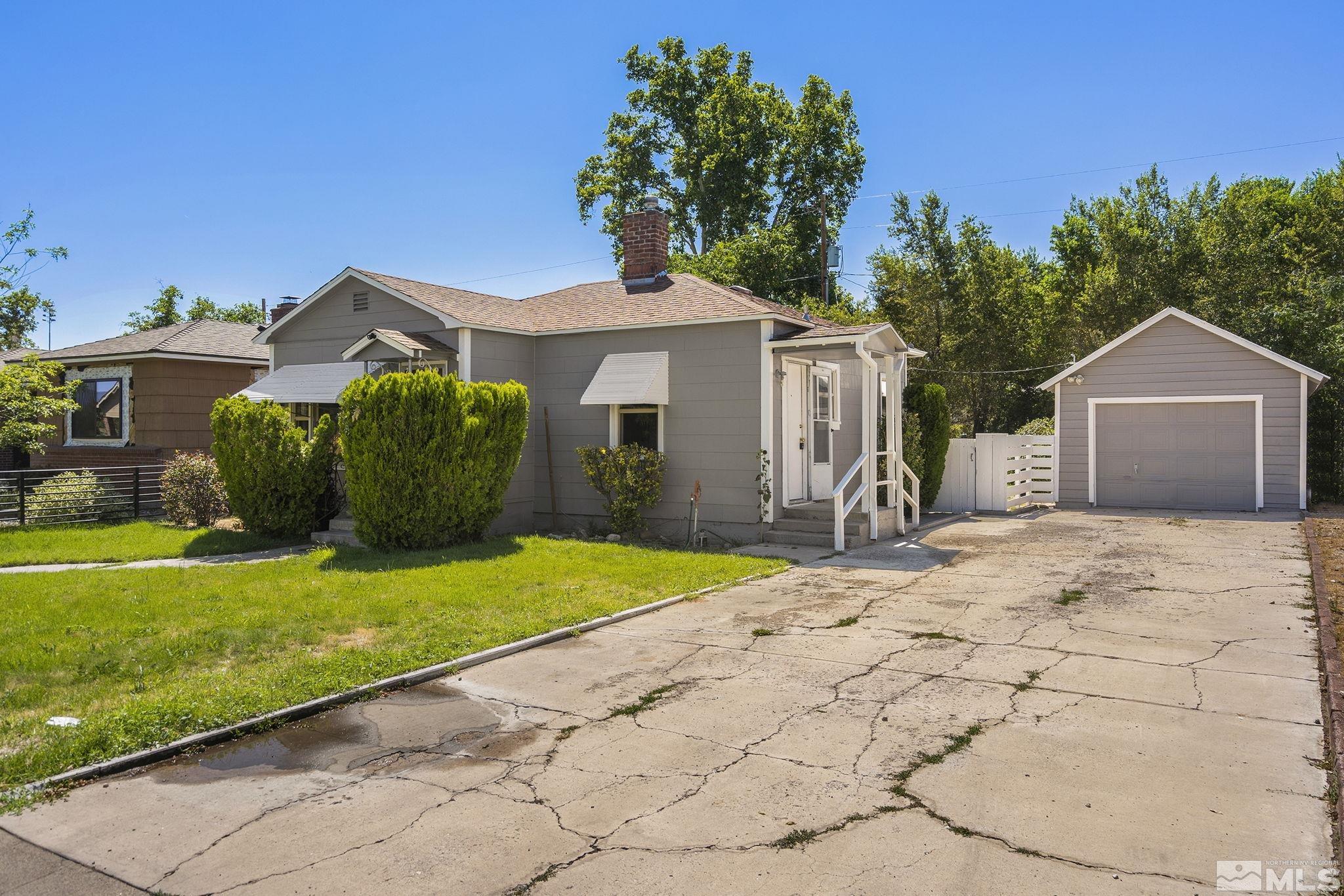 971 Lester Avenue Reno, NV 89502 - Photo 2 of 15 a front view of a house with a yard and garage