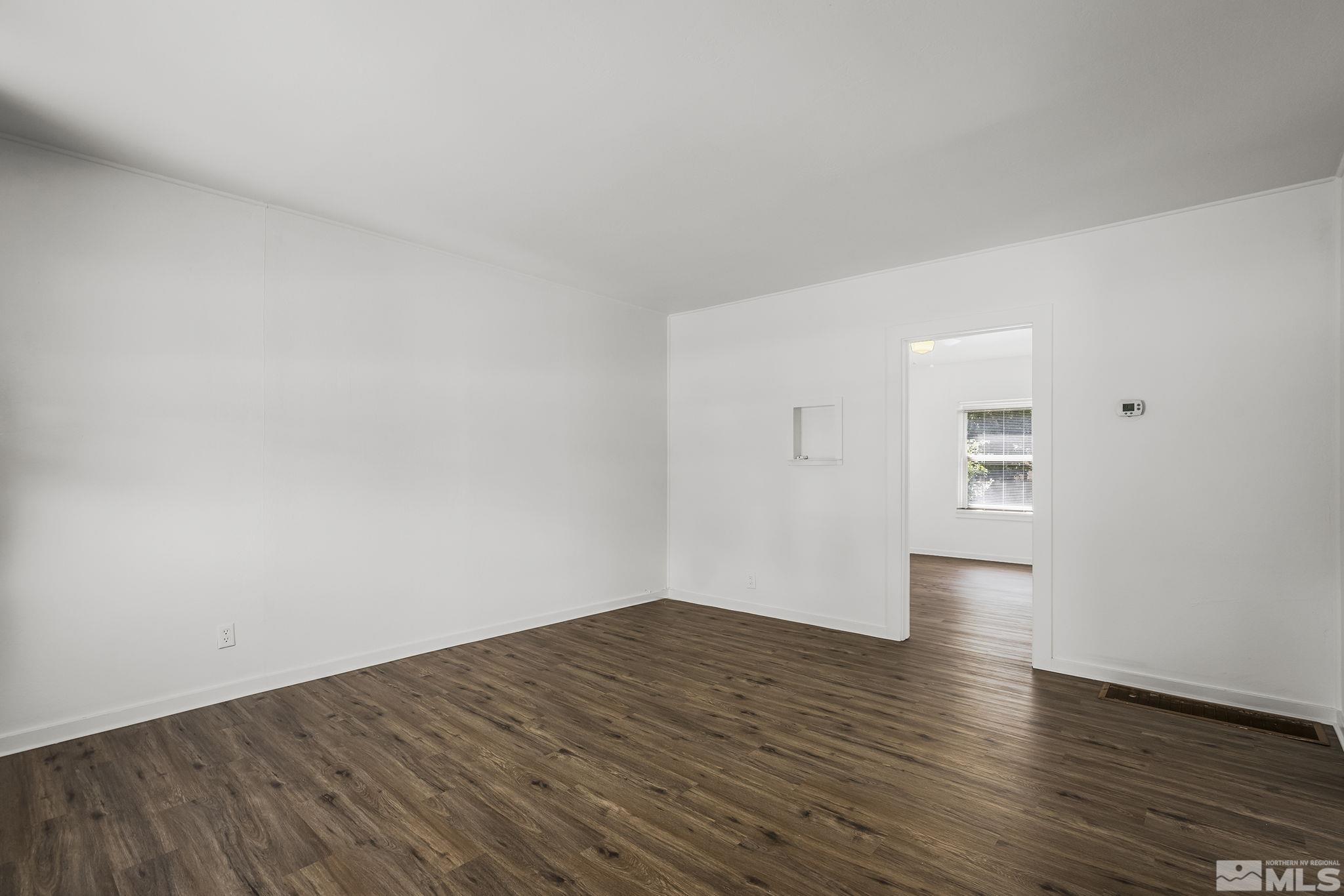 971 Lester Avenue Reno, NV 89502 - Photo 5 of 15 a view of empty room with wooden floor