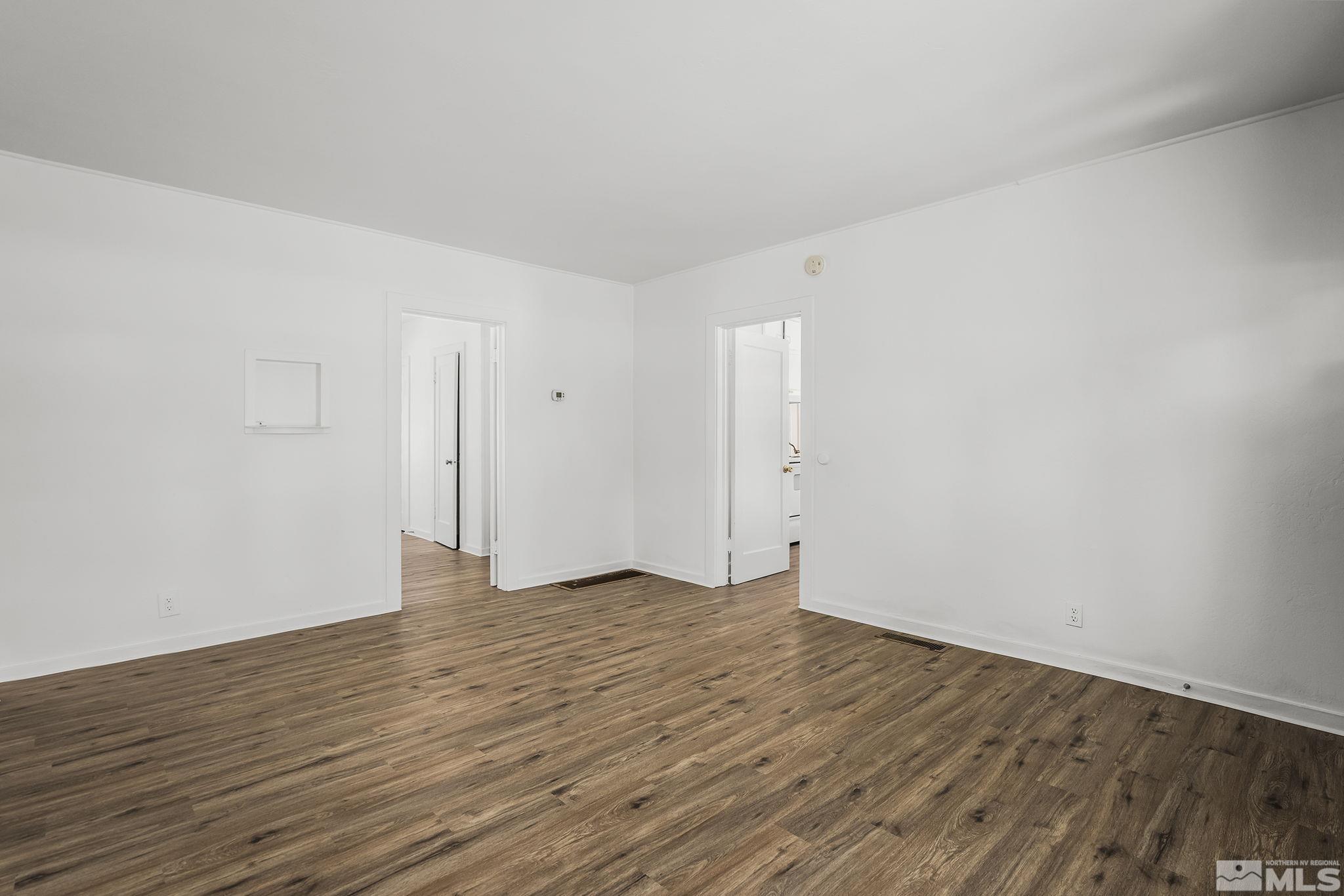 971 Lester Avenue Reno, NV 89502 - Photo 6 of 15 a view of an empty room with wooden floor