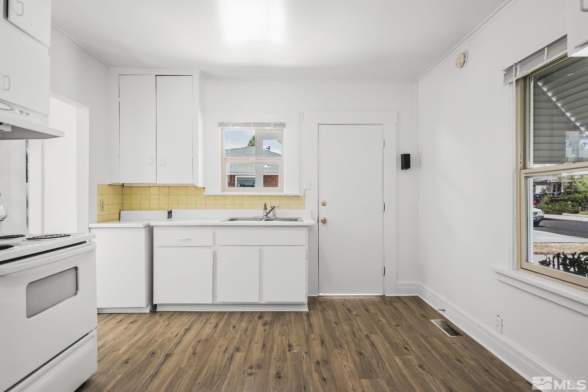 971 Lester Avenue Reno, NV 89502 - Photo 7 of 15 a room with a white cabinets and wooden floor