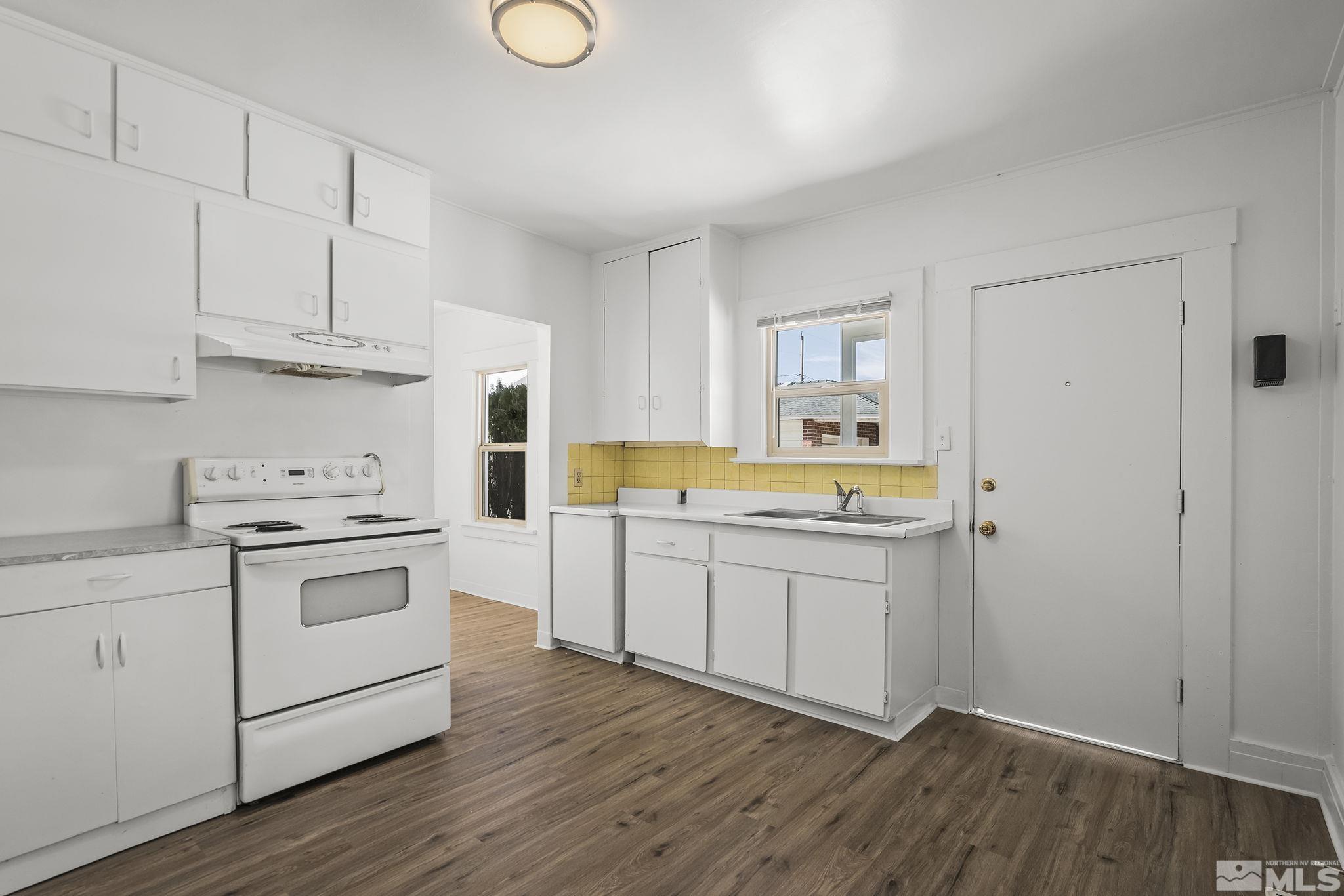 971 Lester Avenue Reno, NV 89502 - Photo 8 of 15 a kitchen with granite countertop white cabinets and white appliances