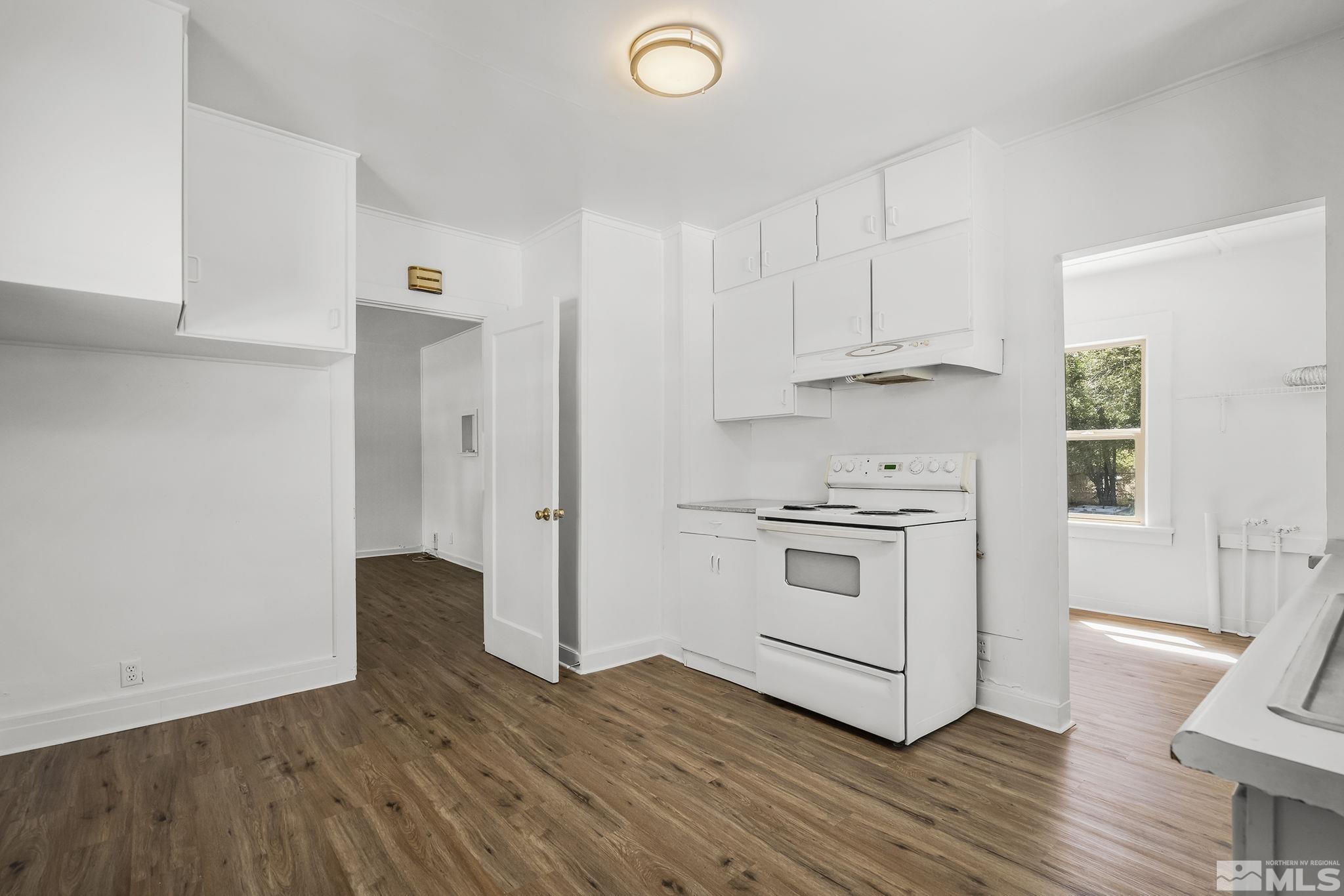 971 Lester Avenue Reno, NV 89502 - Photo 9 of 15 a kitchen with wooden floor and a stove top oven