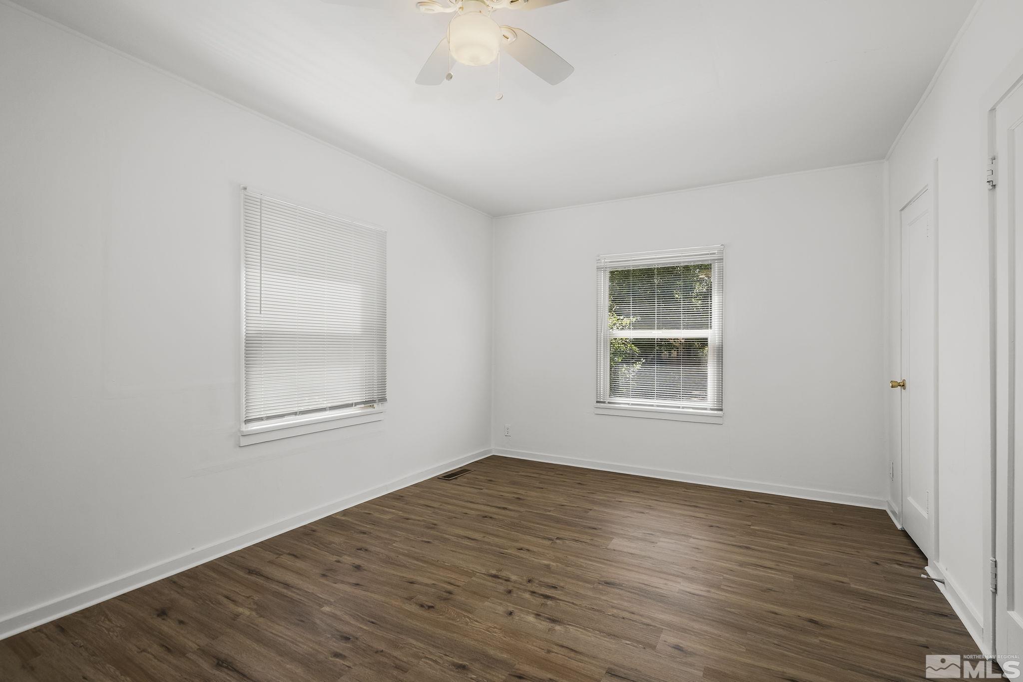 971 Lester Avenue Reno, NV 89502 - Photo 10 of 15 a view of an empty room with wooden floor and a window