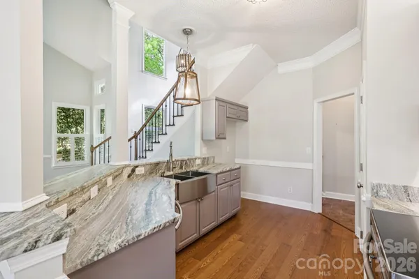 a kitchen with a stove and a wooden floor