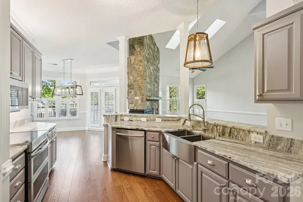 a kitchen with a sink cabinets and wooden floor