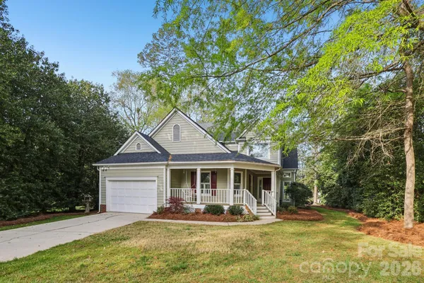 a front view of a house with yard and porch