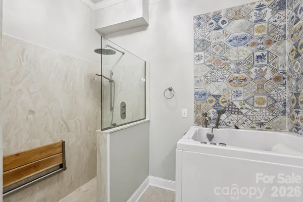 a bathroom with a bathtub and shower