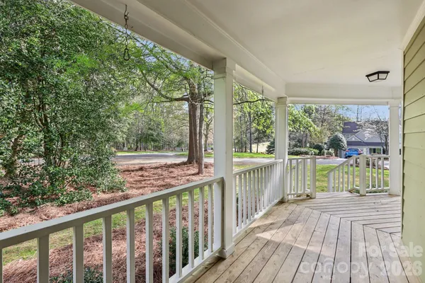 a view of balcony with wooden floor