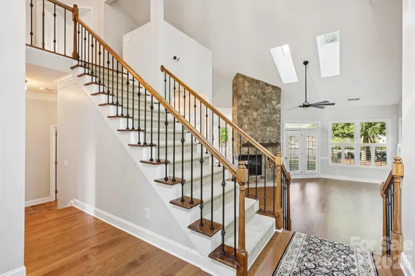 a view of entryway and hall with wooden floor