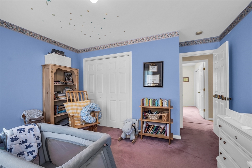 34 Pingry Way Ayer, MA 01432 - Photo 15 of 29 a living room with furniture and a book shelf