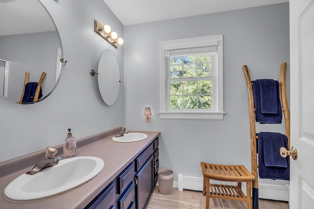 34 Pingry Way Ayer, MA 01432 - Photo 18 of 29 a bathroom with a double vanity sink and a mirror