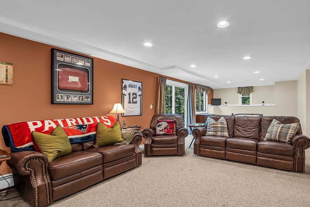 34 Pingry Way Ayer, MA 01432 - Photo 24 of 29 a living room with furniture a refrigerator and a flat screen tv