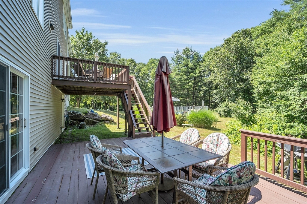 34 Pingry Way Ayer, MA 01432 - Photo 25 of 29 a view of a chairs and table in patio with wooden floor