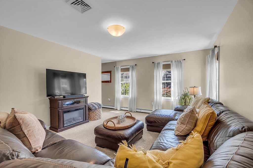 34 Pingry Way Ayer, MA 01432 - Photo 7 of 29 a living room with furniture and a flat screen tv