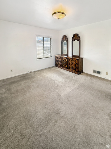 White walls with a window featuring horizontal blinds