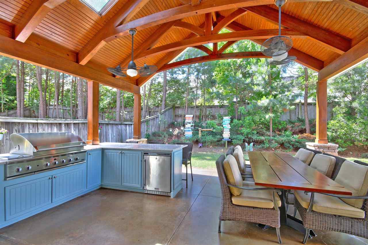 7532 Silver View Lane Raleigh, NC 27613 - Photo 23 of 30 Your own private oasis! This amazing outdoor kitchen is custom built and fantastic! Fitted with a sink, fridge and multi burner grill, there's just no reason to leave your own backyard! Outdoor Kitchen