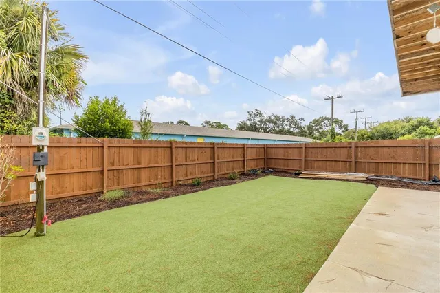 a backyard of a house with table and chairs