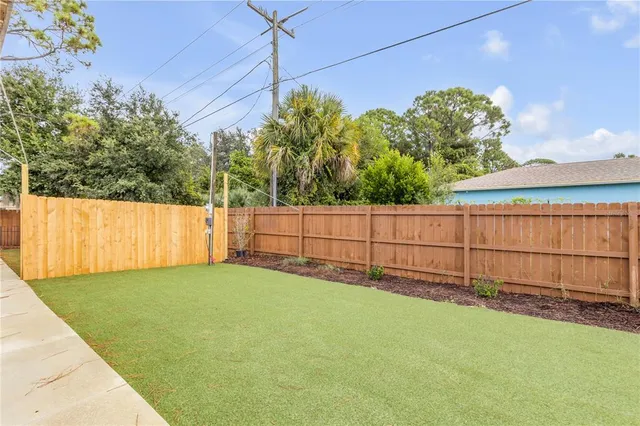 a backyard of a house with wooden fence
