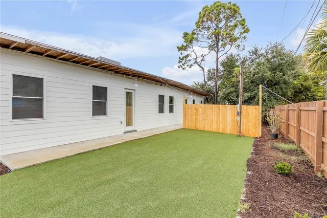 a view of a backyard with a large tree