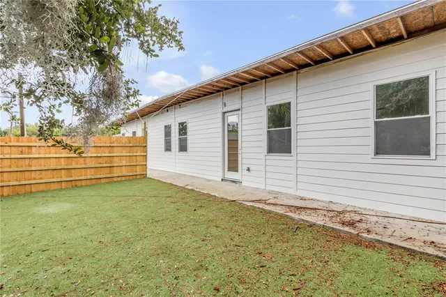 a view of a house with swimming pool and sitting area