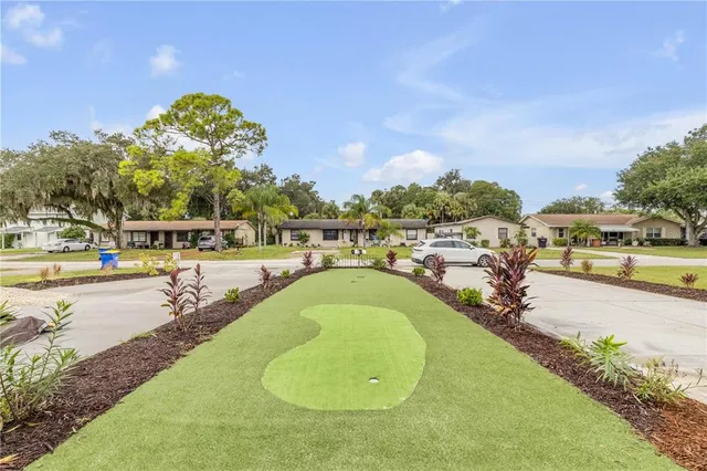 a view of a house with backyard and sitting area
